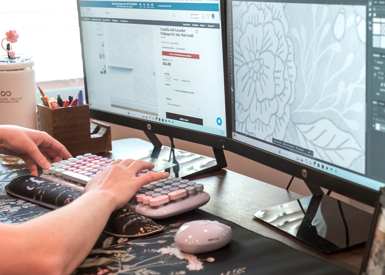 Person working on a customer's order from Limitless Walls, using a computer with two monitors at a desk.