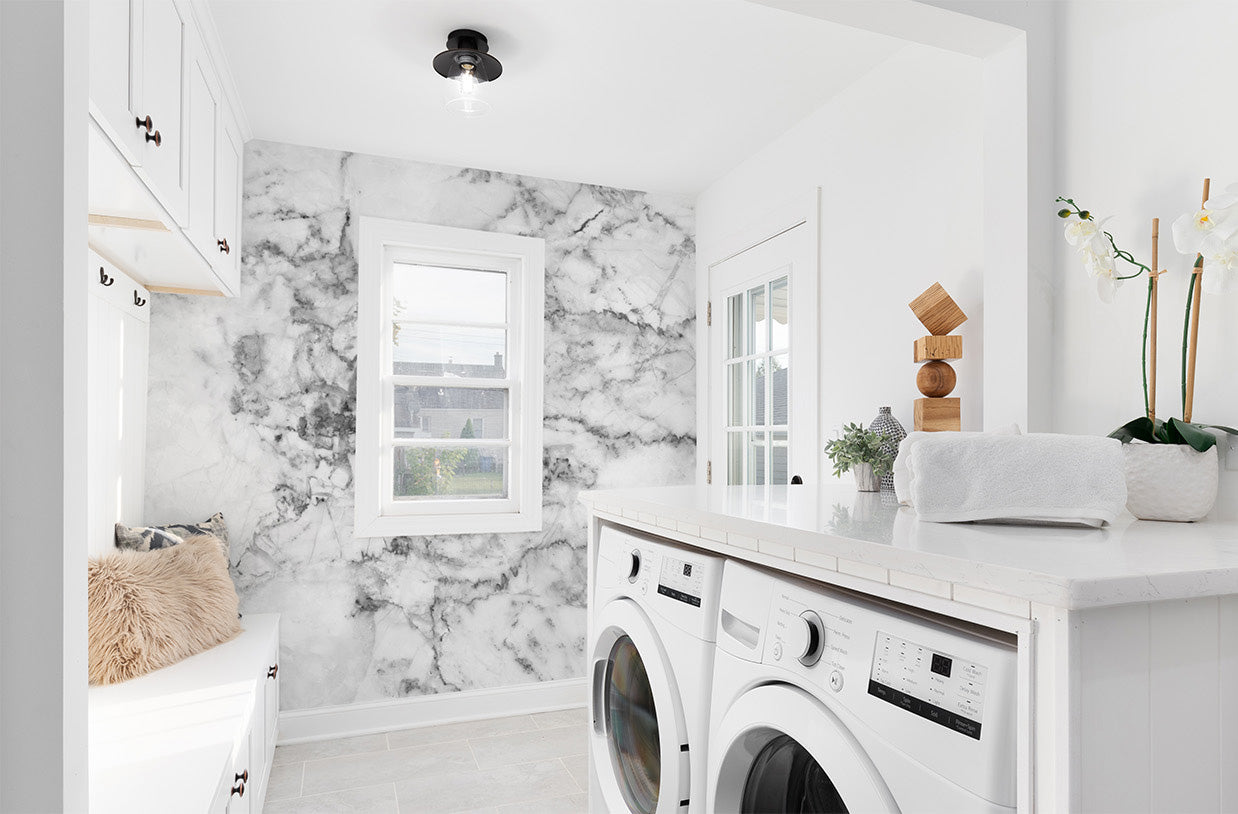 Modern laundry room with marble wallpaper mural and white appliances