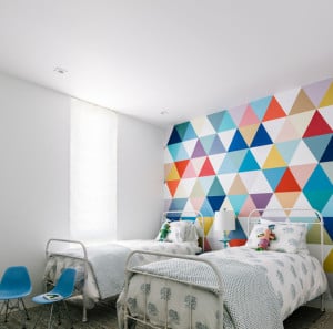 bedroom with multicolored triangular geometric wallpaper